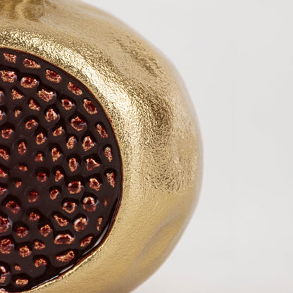 Close view of gold pomegranate decor highlighting crown top and textured red seed detailing for realistic accent