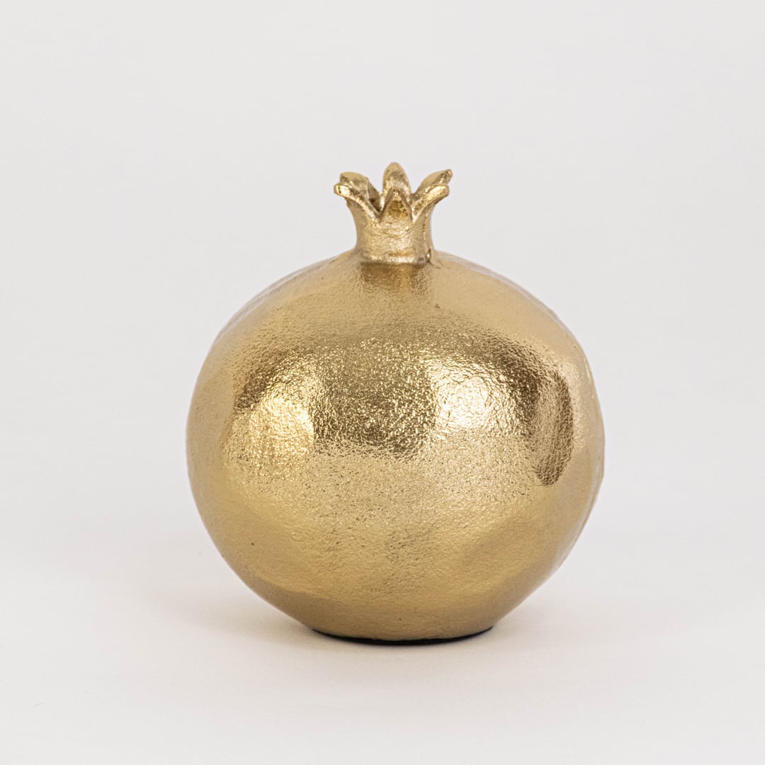 Gold pomegranate decor with crown top and detailed red seed section ideal for tabletop display or festive styling.
