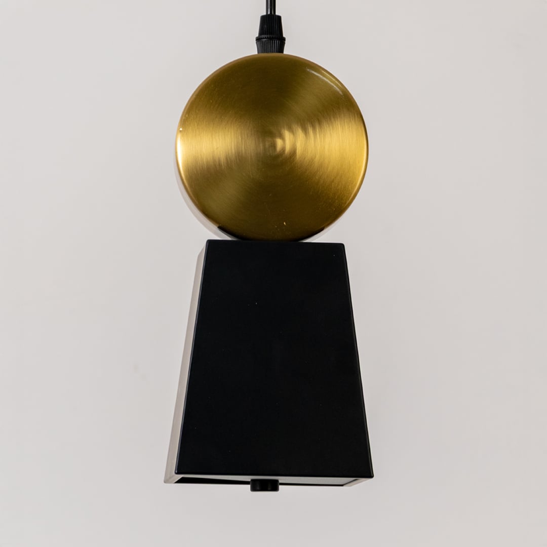 Closeup of pendant light top with gold metal cap and black fabric shade highlighting refined finish premium materials and elegant detailing.
