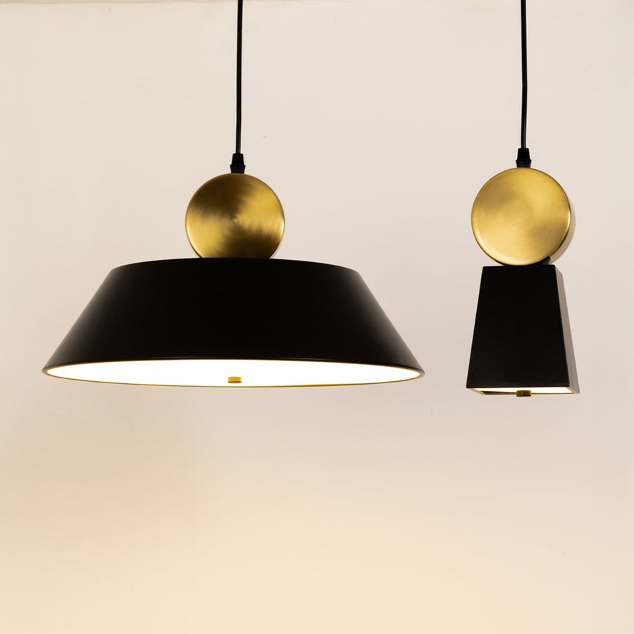 Grouped display of the pendant light showing its matte black taper design brushed gold sphere detail and stylish modern aesthetic variations.