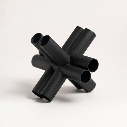Black metal decorative sculpture with geometric pipe design for modern tabletop styling and contemporary home decor.