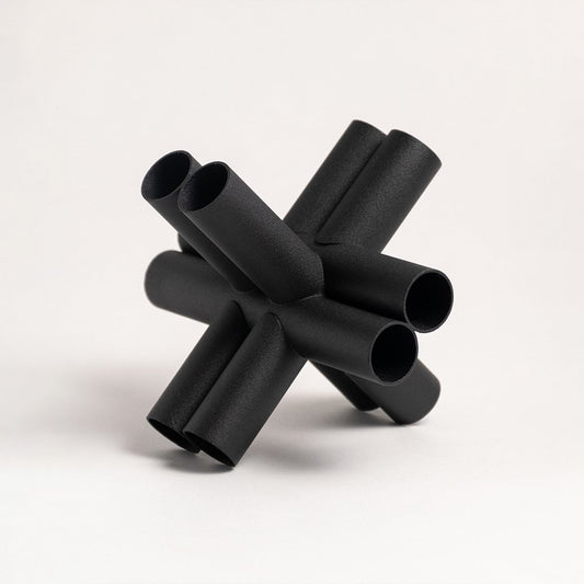 Black metal decorative sculpture with geometric pipe design for modern tabletop styling and contemporary home decor.
