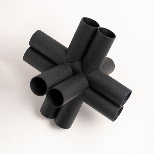 Contemporary black geometric decor sculpture displayed on plain white background for modern styling.