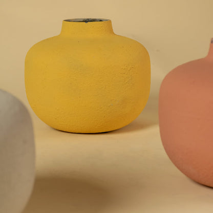 Closeup of yellow metal textured vase showing its rounded shape and detailed matte finish perfect for stylish home decor accents.
