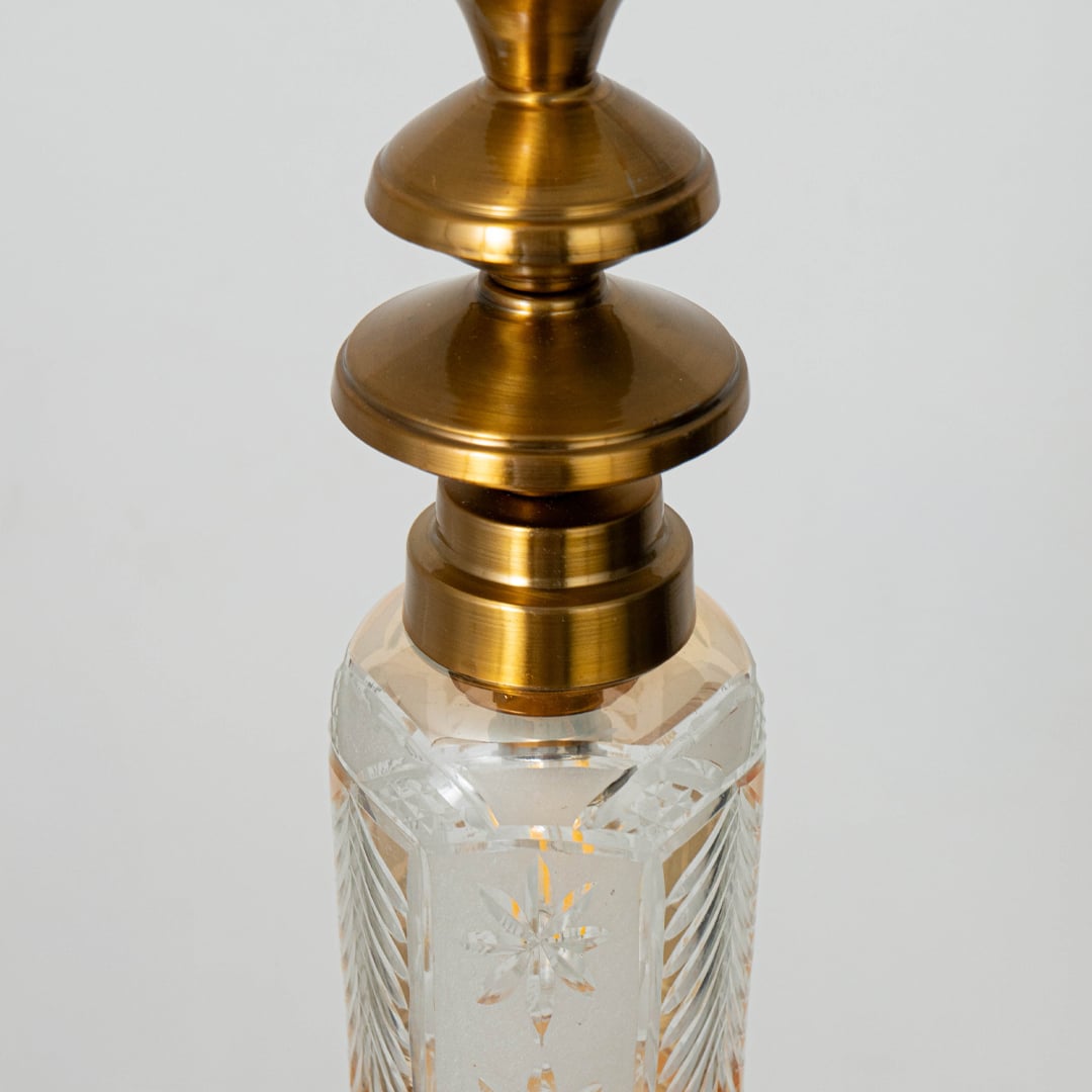 Closeup of patterned glass and gold metal pendant light highlighting intricate texture and premium finish.