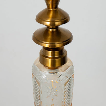 Closeup of patterned glass and gold metal pendant light highlighting intricate texture and premium finish.