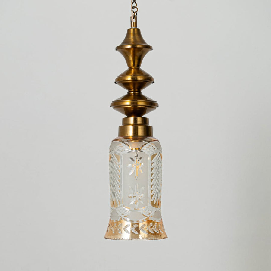 Patterned glass and gold metal pendant light with decorative design for timeless interior styling.