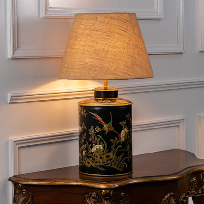 Gilded Phoenix black table lamp illuminated on white background highlighting bold contrast intricate design and ambient interior lighting.