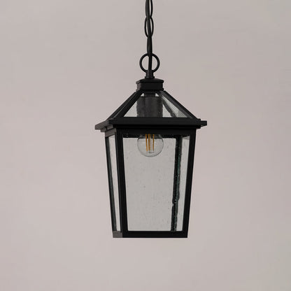 Black outdoor lantern with the light switched off shown on a white background featuring clear textured glass and a modern square frame design.