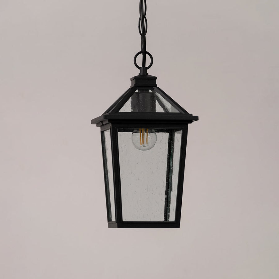Black outdoor lantern with the light switched off shown on a white background featuring clear textured glass and a modern square frame design.