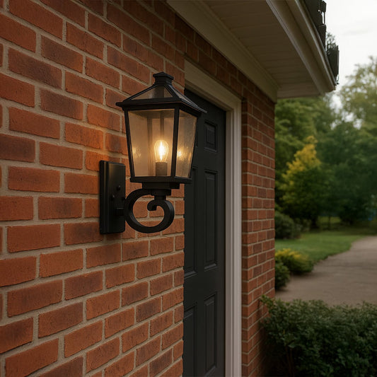 Black outdoor wall lantern with clear textured glass adding warm classic lighting to a modern entryway or garden wall decor.