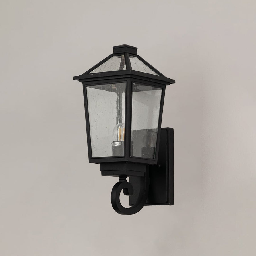 Black outdoor wall lantern with clear textured glass shown on a bright white background with lights off for a classic look.