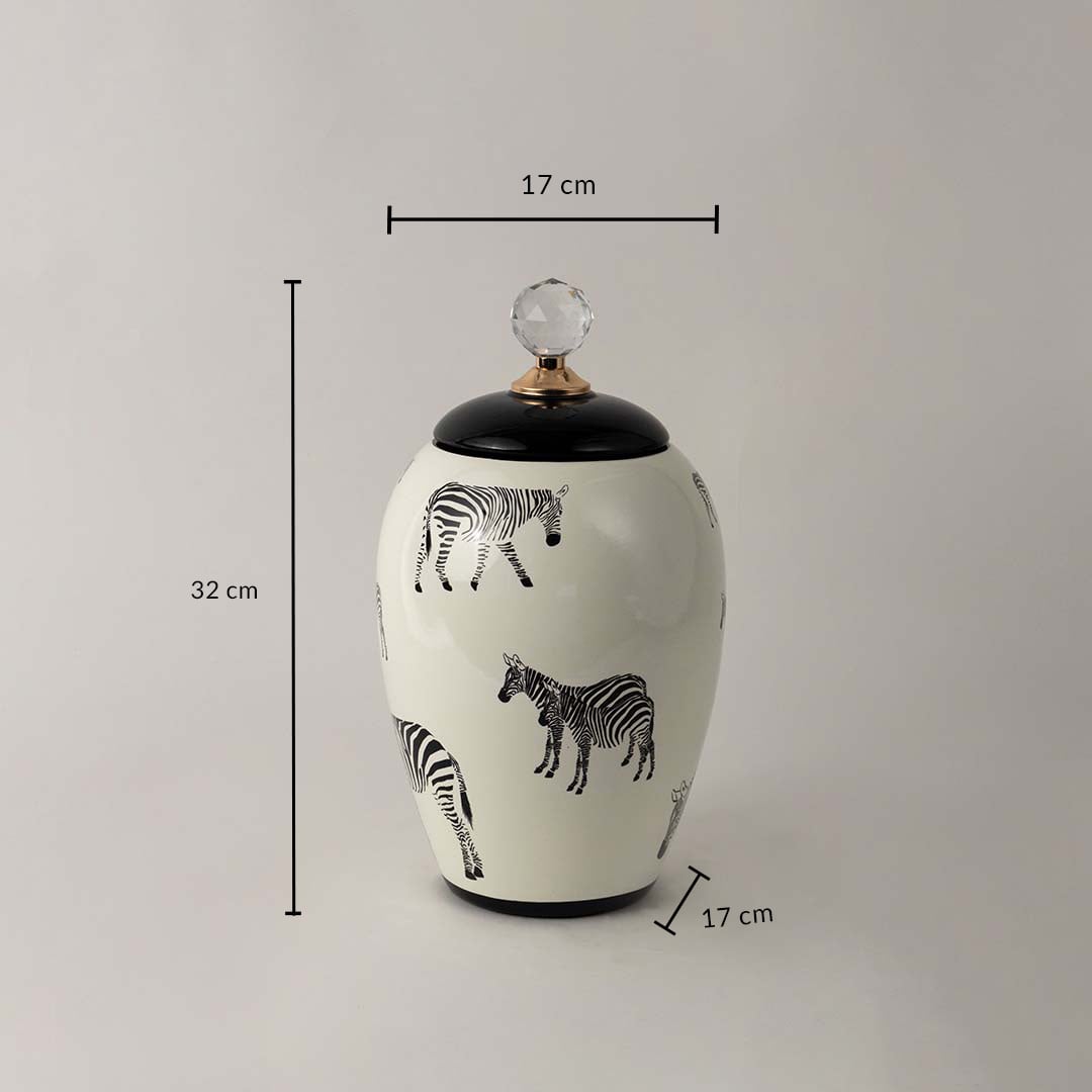 White ceramic decor jar with zebra artwork and crystal knob shown with 32 cm height and 17 cm width dimensions.
