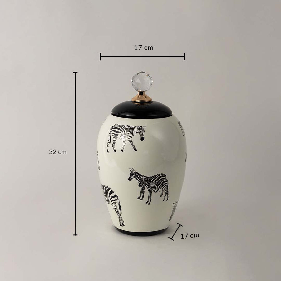 White ceramic decor jar with zebra artwork and crystal knob shown with 32 cm height and 17 cm width dimensions.