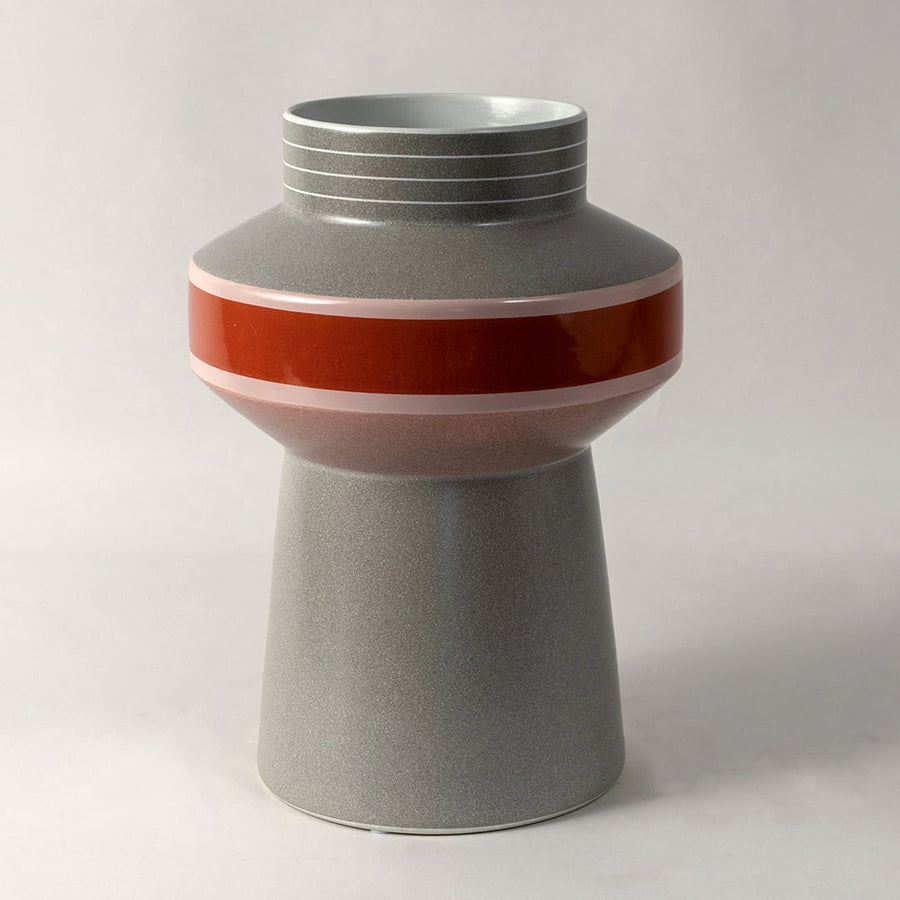 Elegant grey ceramic vase with red and pink glossy stripe design ideal for modern shelf and table decoration on white background.