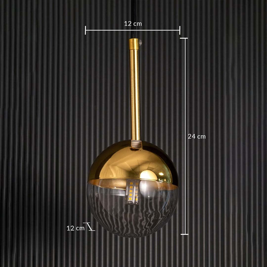 A gold and glass pendant light shown with clear dimensions displaying a 12 cm width a 12 cm depth and a 24 cm height against a dark textured backdrop.