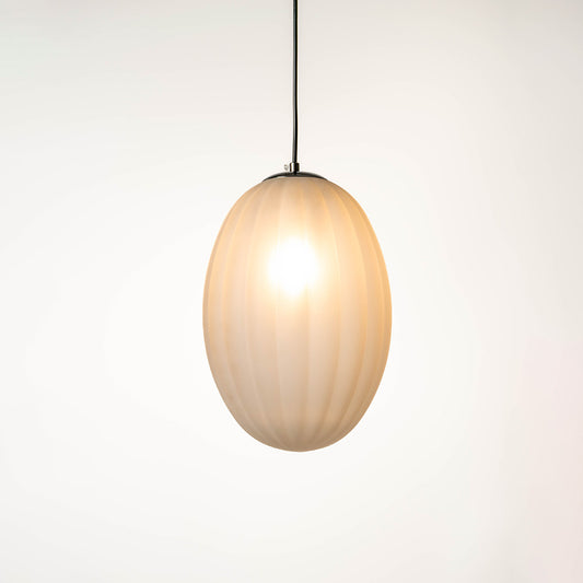 Oval glass pendant light with warm glow hanging from ceiling on neutral background modern minimal lighting for dining and living room decor.