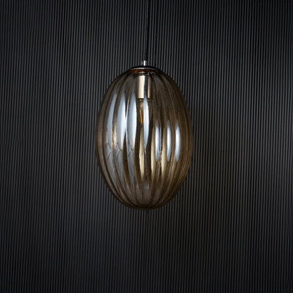 Pendant light turned off against a black background showing its silhouette and smooth finish with clear visibility of its refined contours.