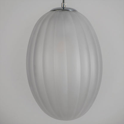Closeup view of frosted ribbed glass pendant light shade showcasing smooth matte texture soft diffusion and elegant ceiling lighting style.