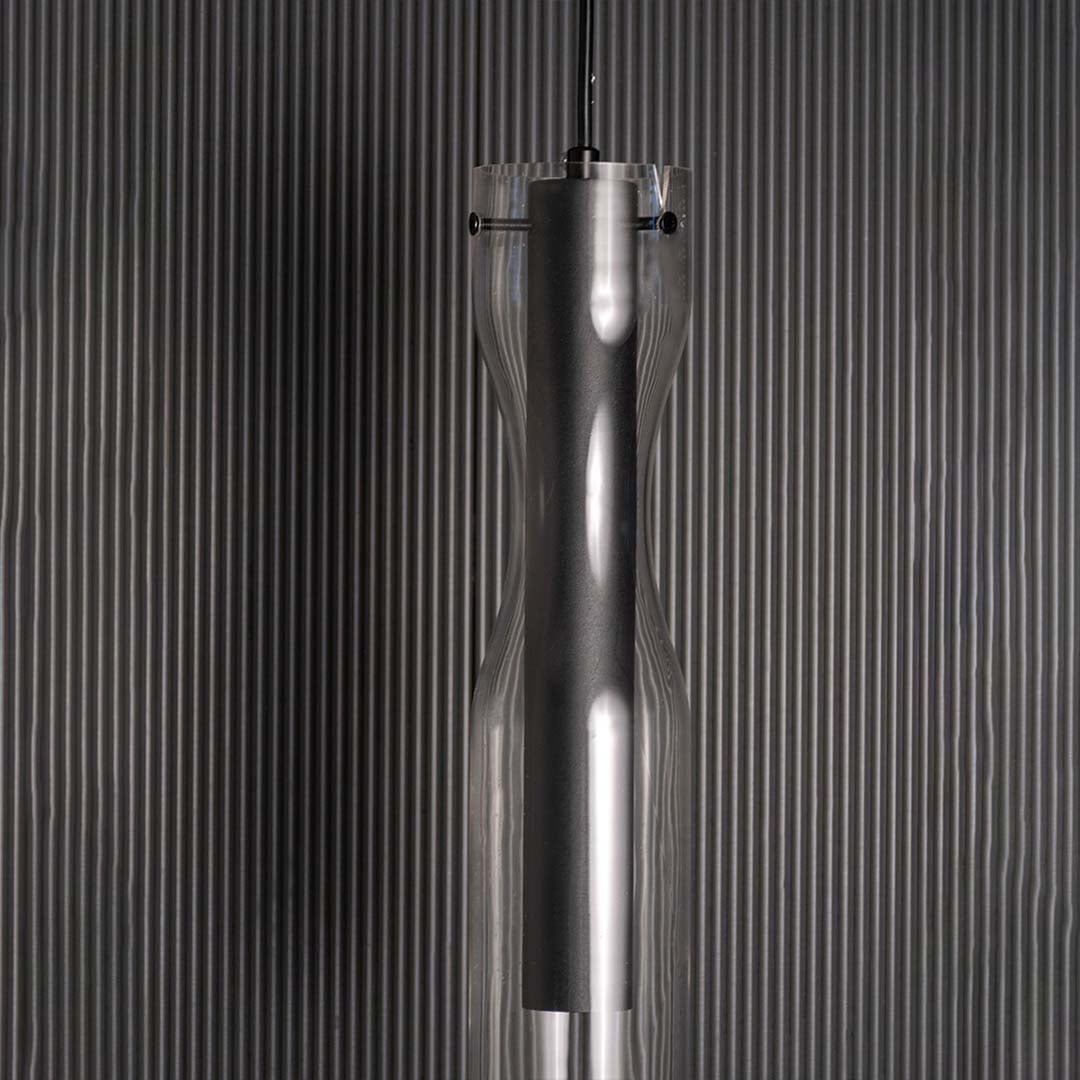 Zoomed view of the pendant light showing the smooth black inner cylinder and crystal clear outer glass layer crafted for a refined contemporary look.