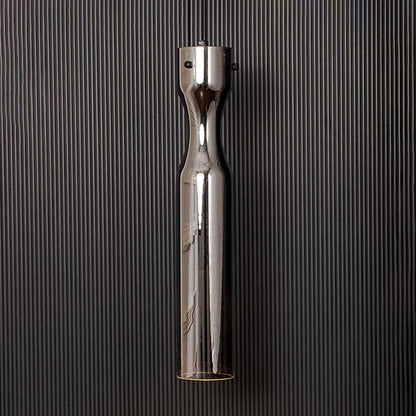 Modern chrome pendant ceiling light illuminated on back background for elegant dining room and cafe interior lighting.