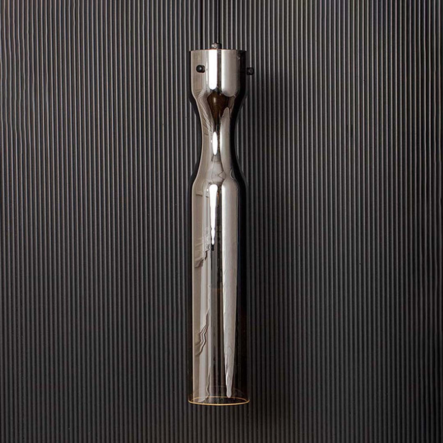 Modern chrome pendant ceiling light illuminated on back background for elegant dining room and cafe interior lighting.