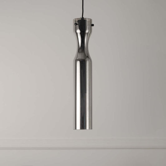 Slim brass pendant light with clear textured glass shade on white background for stylish interior lighting.