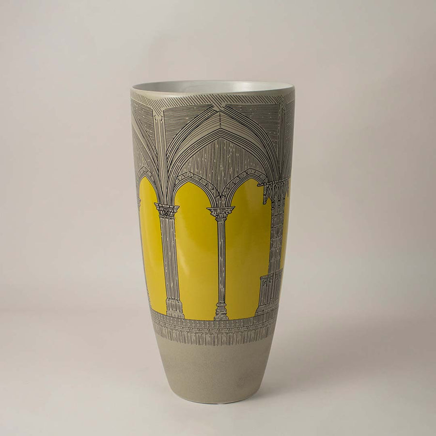 Tall grey ceramic vase with yellow arch pattern for sophisticated home decor and artistic interior shelf styling.