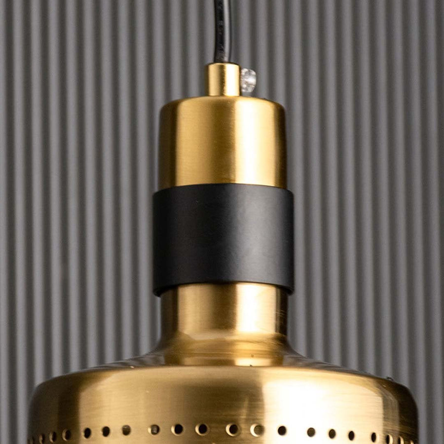 A detailed close view of the perforated gold metal pendant light highlighting its brushed finish and cylindrical shape suited for elegant home decor.
