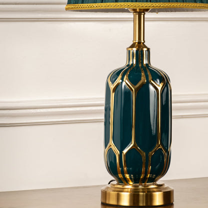 Closeup of table lamp showing detailed emerald ceramic base with metal accents and pleated green shade highlighting refined craftsmanship suited for stylish interior home decor lighting.