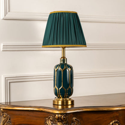 Emerald ceramic table lamp with pleated green shade and metal base shown switched off on a clean white background highlighting its rich decorative silhouette for interior decor.