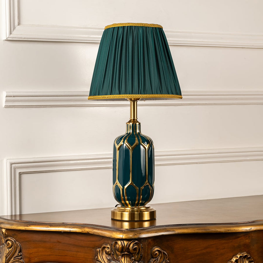 Emerald ceramic table lamp with pleated green shade and metal base shown switched off on a clean white background highlighting its rich decorative silhouette for interior decor.