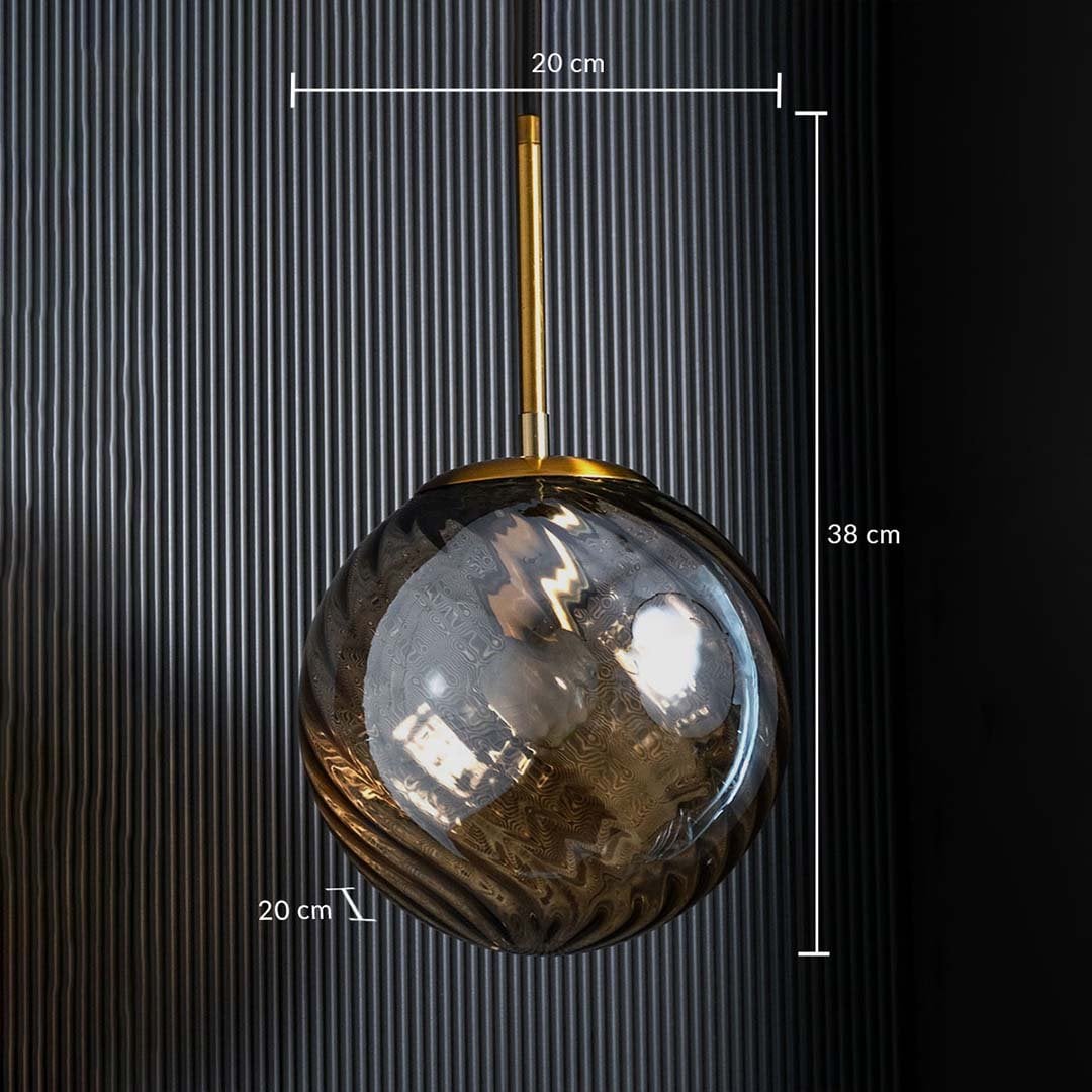 A gold and amber glass pendant light shown with 20 cm width 20 cm depth and 38 cm height measurements highlighting its compact round design.