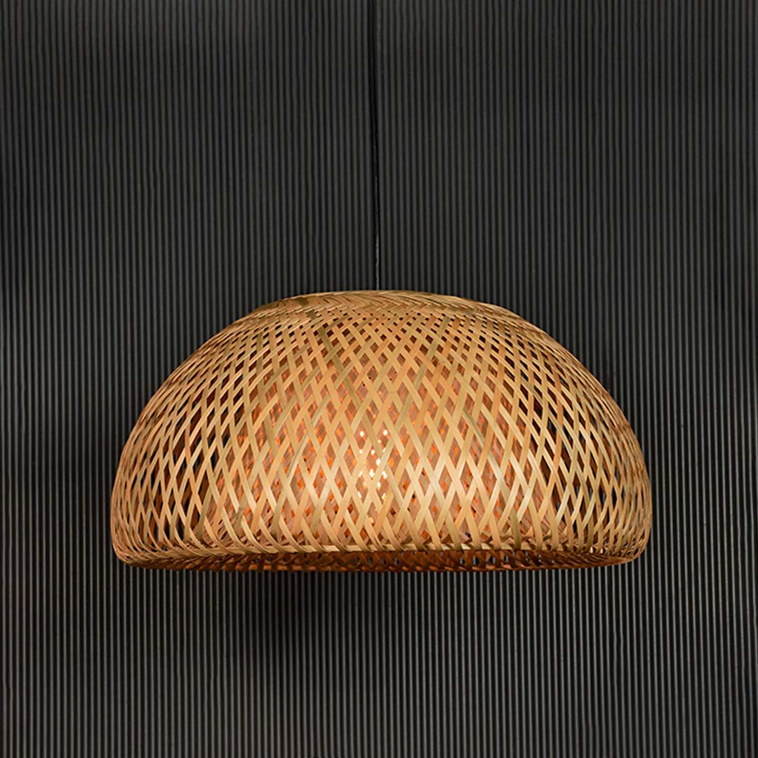 Handwoven rattan pendant light with natural texture designed for bohemian decor.