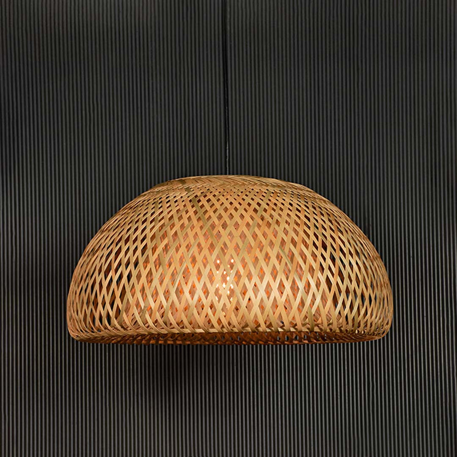 Handwoven rattan pendant light with natural texture designed for bohemian decor.