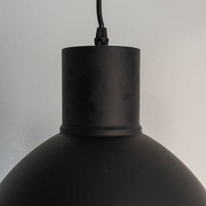 Close view of the cylindrical top neck connecting to the black dome shade highlighting the sturdy metal construction detail.