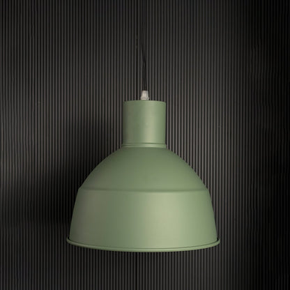 Sleek green industrial pendant light fixture turned off isolated on a pitch black background for a high contrast and dramatic presentation.
