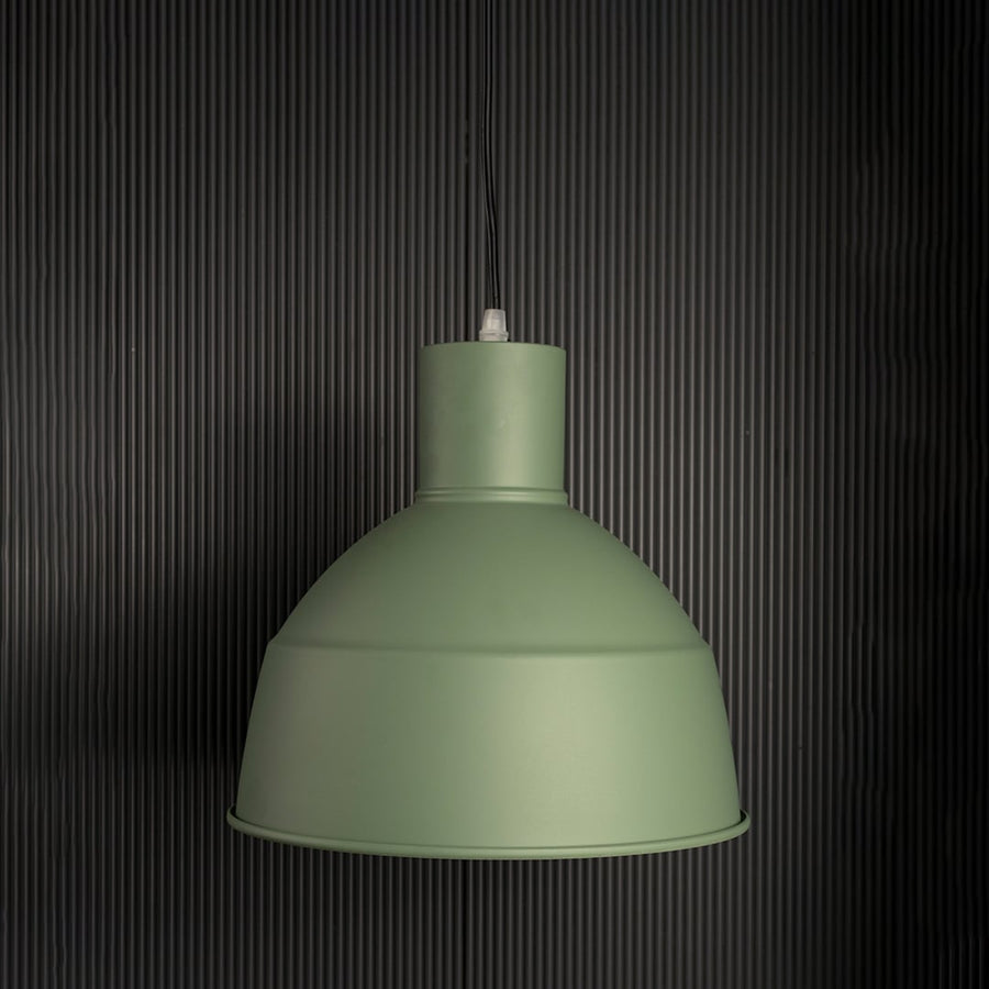 Sleek green industrial pendant light fixture turned off isolated on a pitch black background for a high contrast and dramatic presentation.