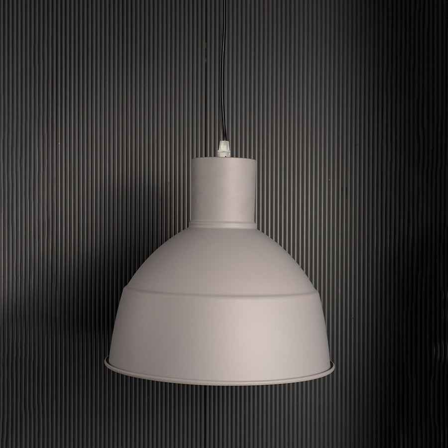 Grey pendant light with light off on white background featuring industrial-inspired dome shade.