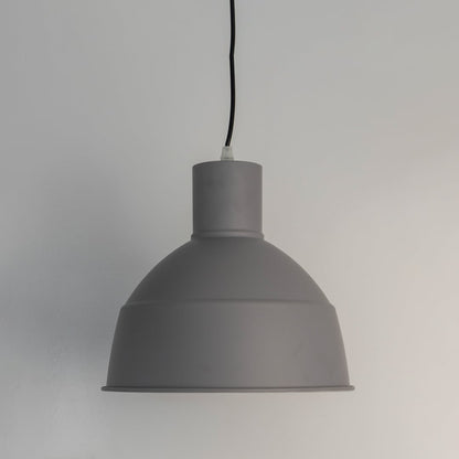 Grey pendant light with light off on white background featuring industrial-inspired dome shade.