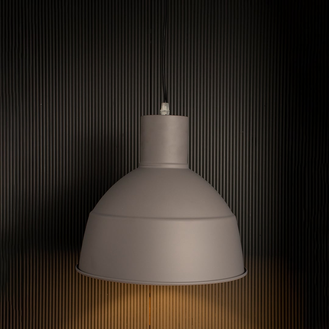 Grey pendant light glowing on white background showing dome-shaped matte finish design.