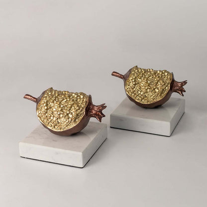 Set of gold and brown decorative pomegranate sculptures for elegant shelf styling and luxury home decor displays.