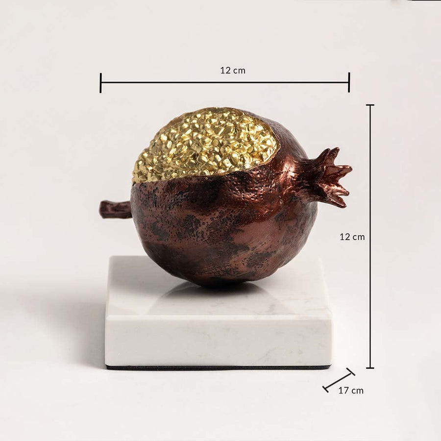 Golden pomegranate sculpture on marble base with 12 cm height and 17 cm width dimensions.