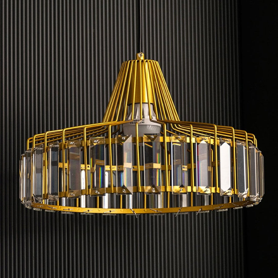 Gold crystal pendant light shown with lights off against a black textured background highlighting its intricate golden frame and crystal arrangement clearly.
