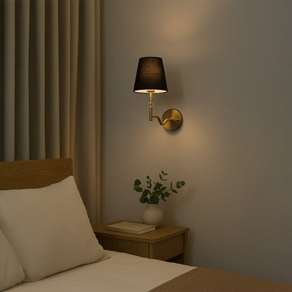 Gold metal wall light with black fabric shade and crystal detail styled in a modern room adding warm ambient lighting for bedrooms hallways and living areas.