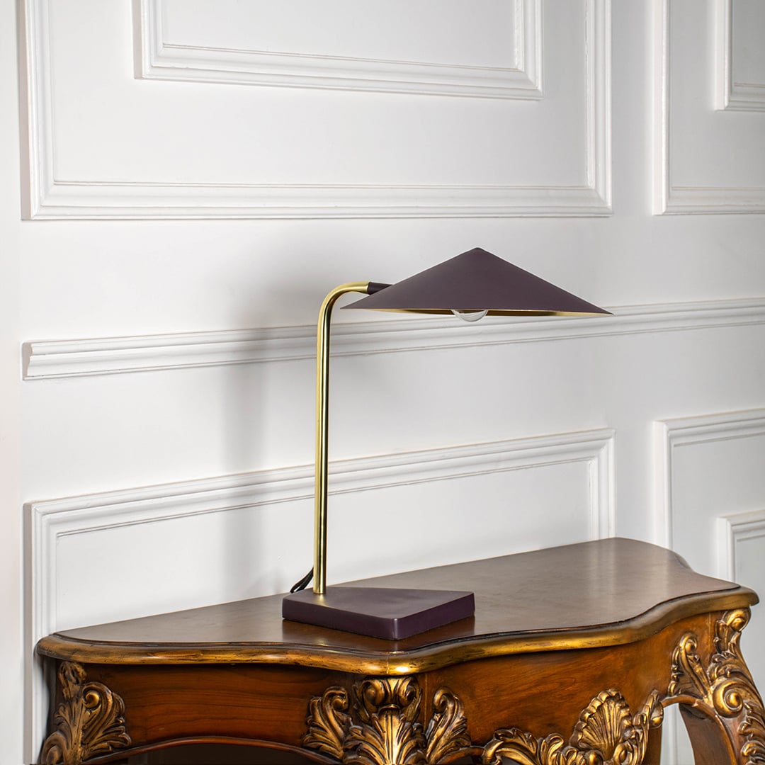 Gold metal table lamp with brown geometric shade displayed off on white background highlighting elegant modern style.