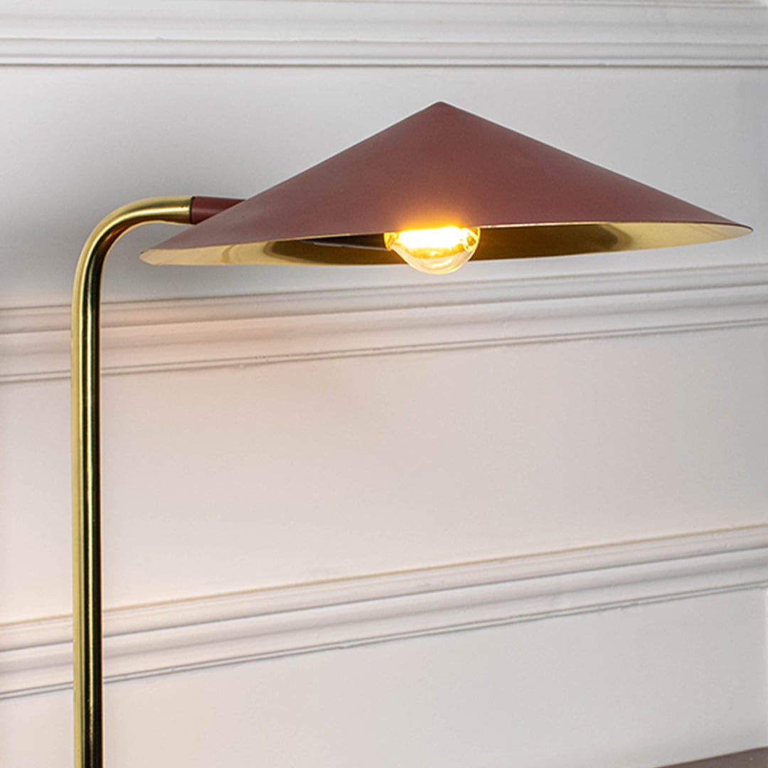 Brass desk lamp with geometric metal shade and warm LED glow showcasing modern craftsmanship and elegant design.