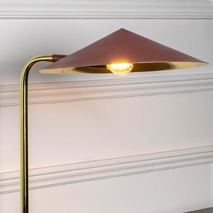 Brass desk lamp with geometric metal shade and warm LED glow showcasing modern craftsmanship and elegant design.