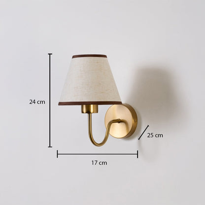 Gold wall sconce with beige shade shown with 24 cm height 17 cm width and 25 cm depth for accurate placement.