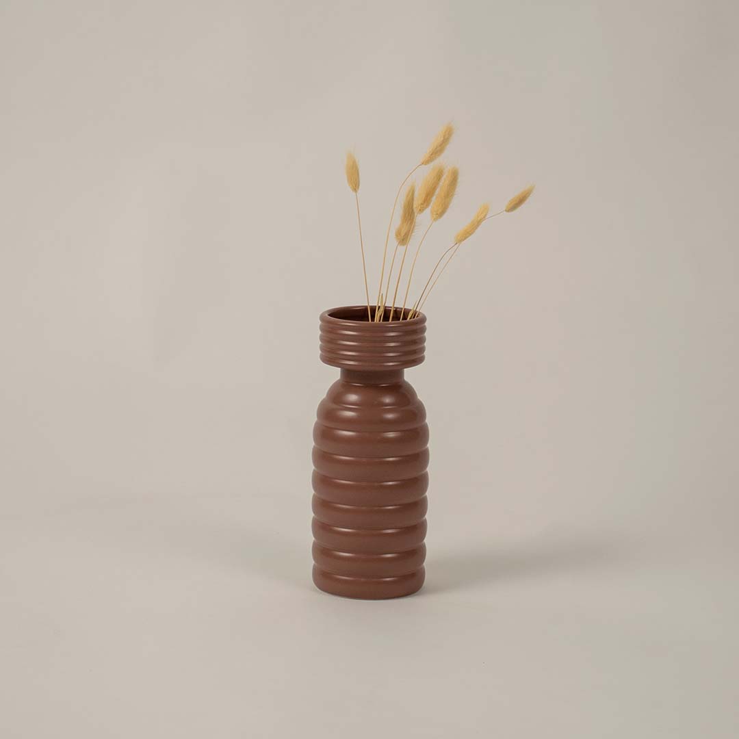 Modern brown ribbed ceramic vase styled for home decor creating a warm earthy accent on shelves or side tables.